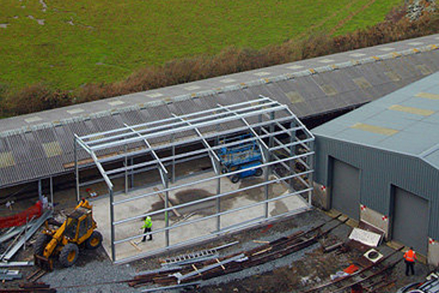 Aerial shot of building under construction in train yard