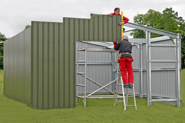 Two men constructing a green building